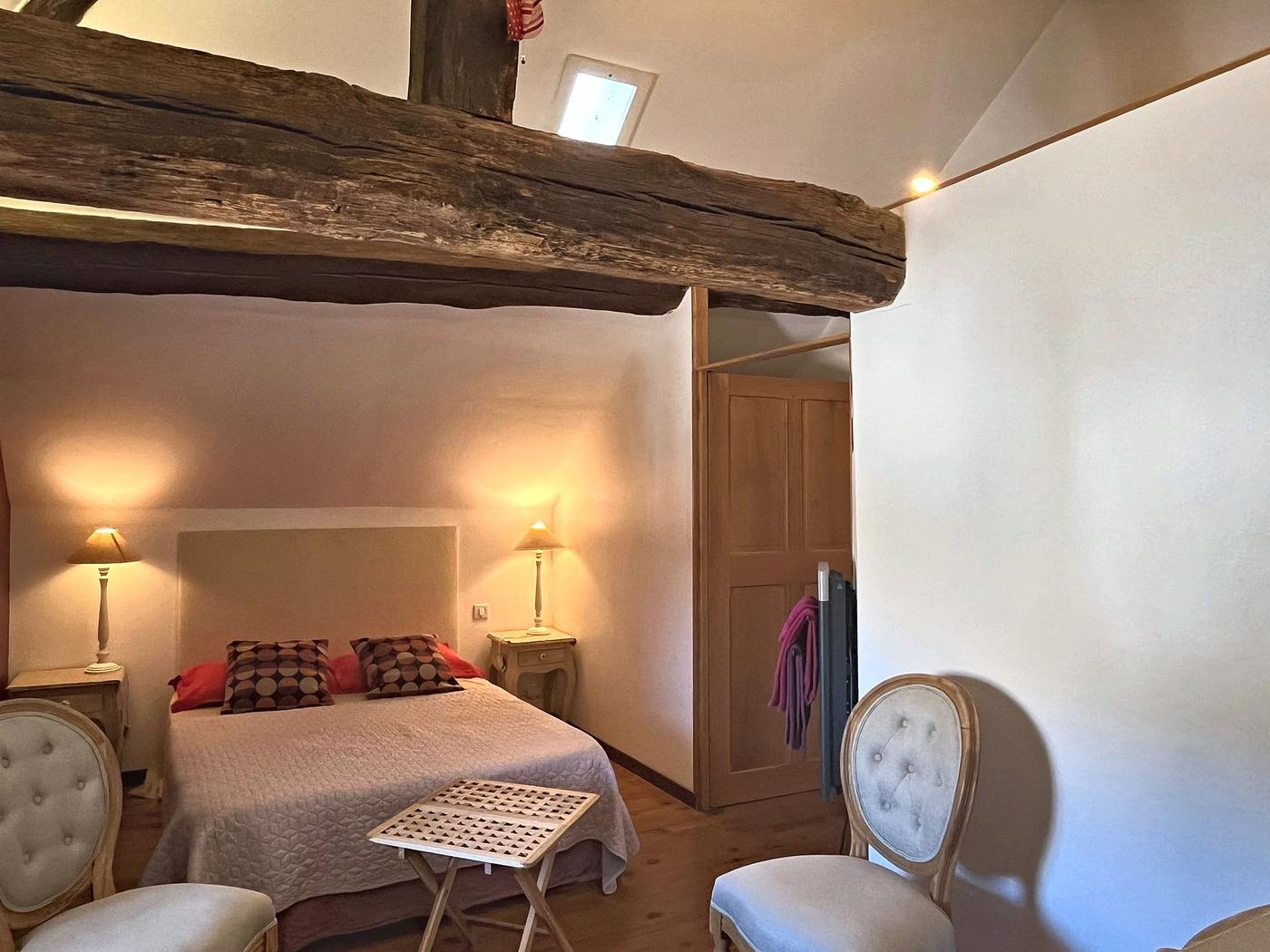 La chambre Le Colombier, ses poutres apparentes et son lit double