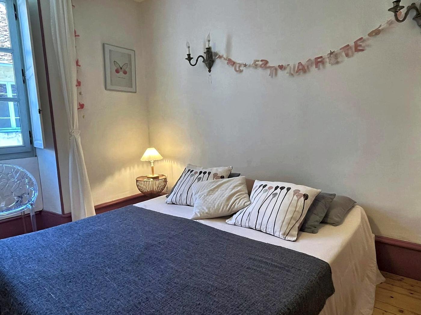 La chambre Le Chanaie, son lit double et sa guirlande